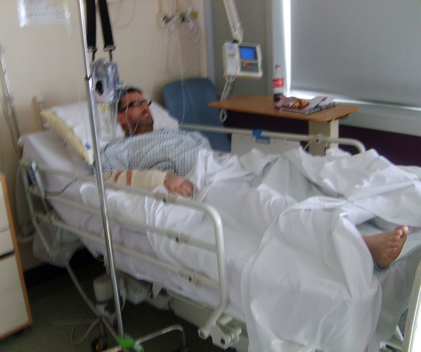 Darren Moore in bed in Antrim Area Hospital after being attacked in 2013
